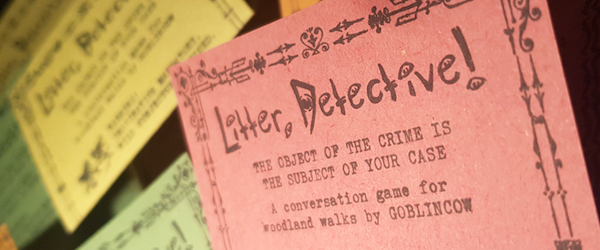 close up of the front of 'Litter, Detective!' on recycled red paper