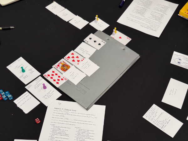 A photograph of the centre of the table towards the end of the game. the main timeline has split, and a new timeline with a green figure on it has been created